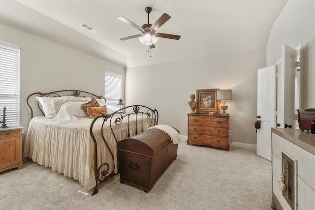 carpeted bedroom with ceiling fan and vaulted ceiling