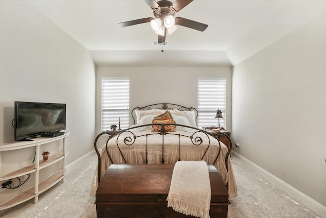 carpeted bedroom featuring ceiling fan and multiple windows