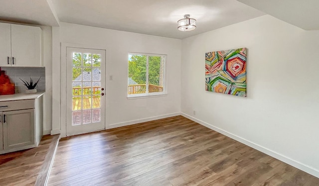 entryway with wood-type flooring and a chandelier