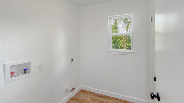 clothes washing area with hookup for an electric dryer, hardwood / wood-style floors, and washer hookup