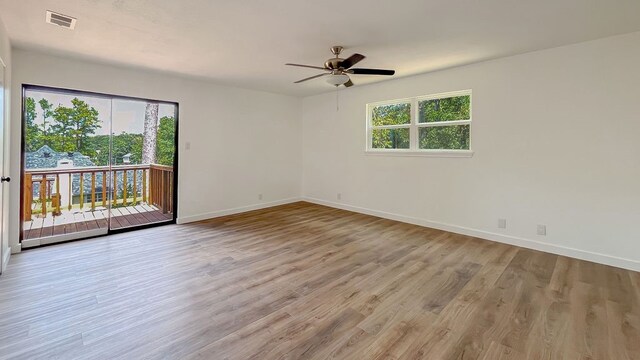 spare room with hardwood / wood-style floors and ceiling fan