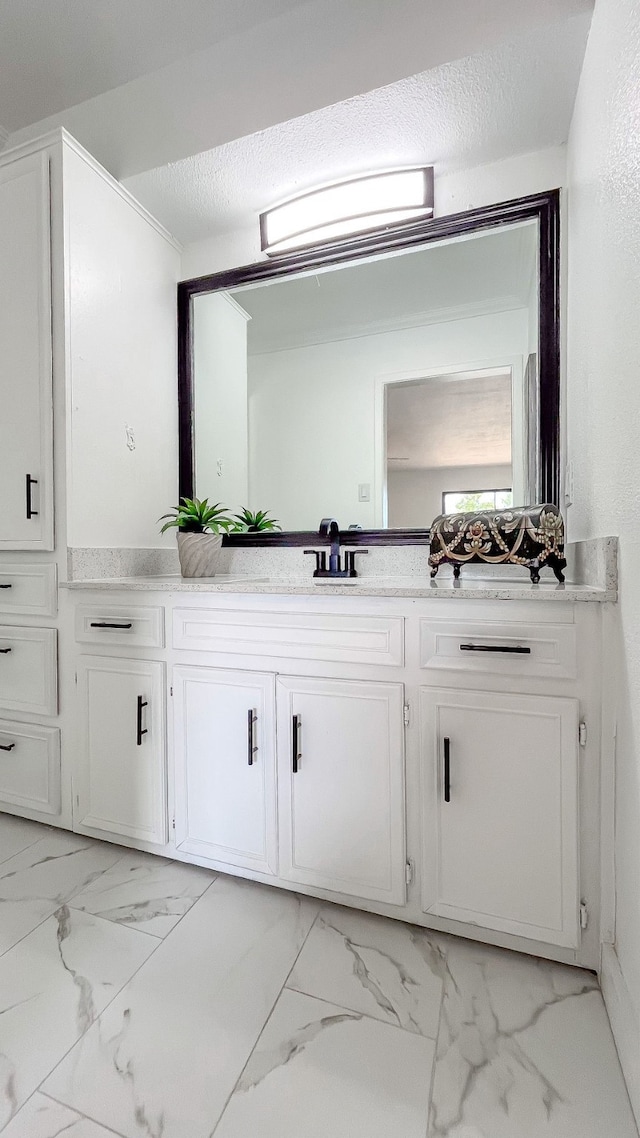 bathroom with a textured ceiling and vanity