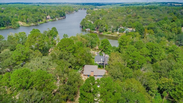 aerial view with a forest view and a water view