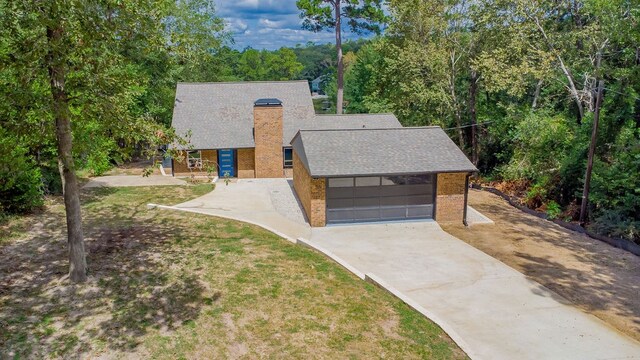 view of front of house with a front lawn and a garage