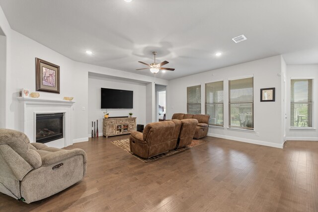 living room with dark hardwood / wood-style flooring, plenty of natural light, and ceiling fan