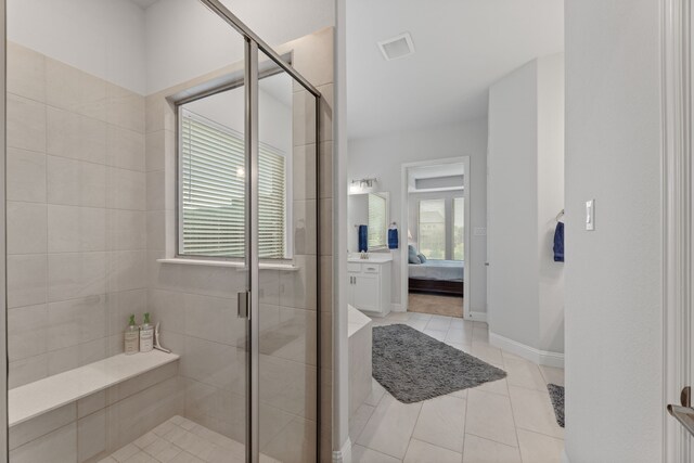 bathroom featuring tile patterned flooring and a shower with shower door