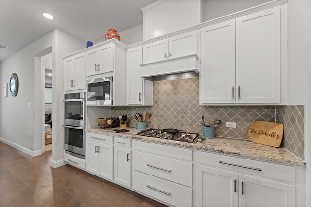 kitchen featuring light stone countertops, custom exhaust hood, stainless steel appliances, dark hardwood / wood-style flooring, and white cabinetry