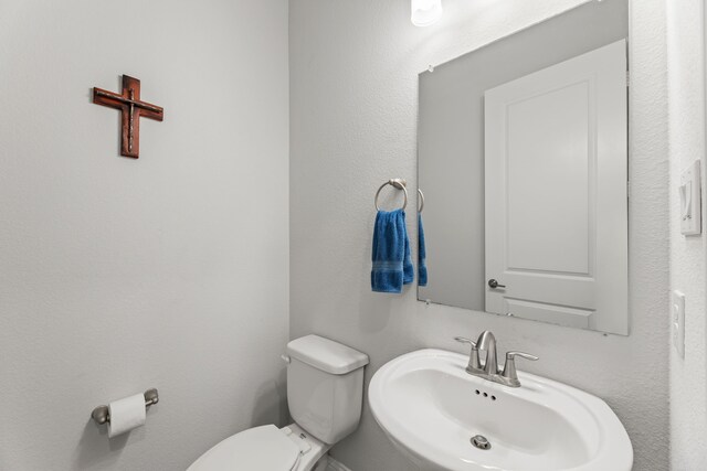 bathroom with toilet and sink