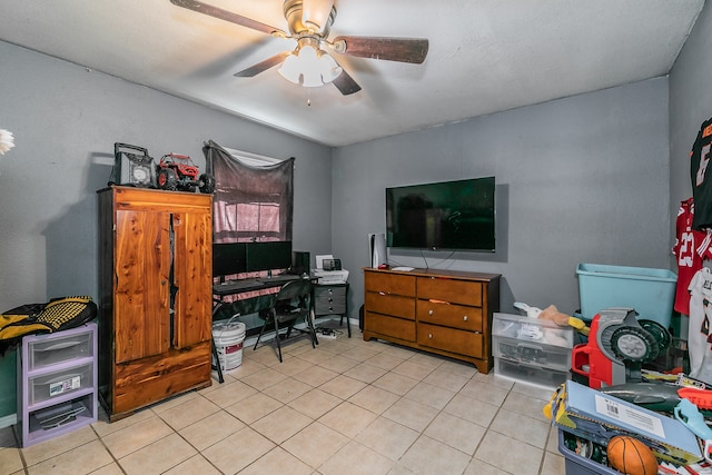 tiled home office featuring ceiling fan