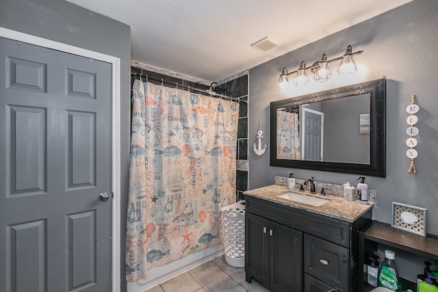 bathroom featuring tile patterned flooring, vanity, and shower / bath combo