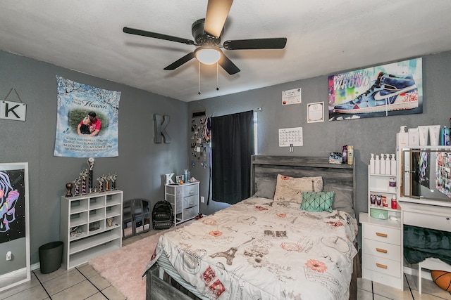 tiled bedroom featuring a textured ceiling and ceiling fan