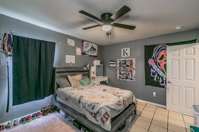 tiled bedroom featuring ceiling fan