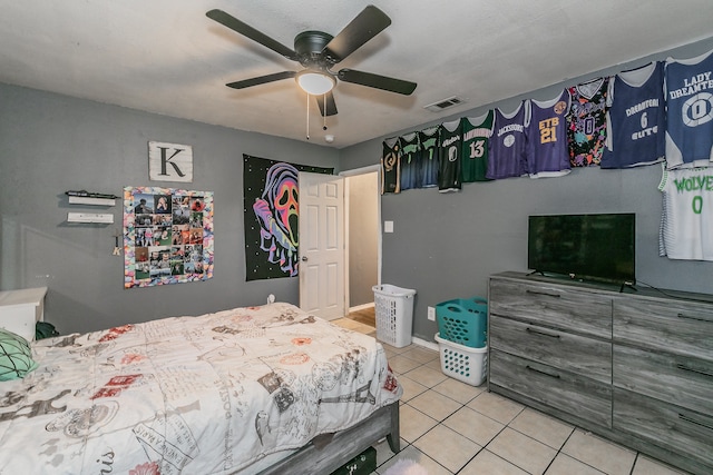 bedroom with ceiling fan and light tile patterned floors