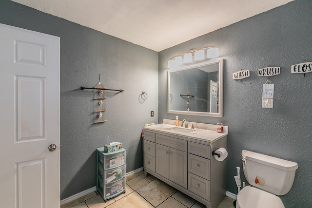 bathroom featuring vanity, toilet, and tile patterned floors