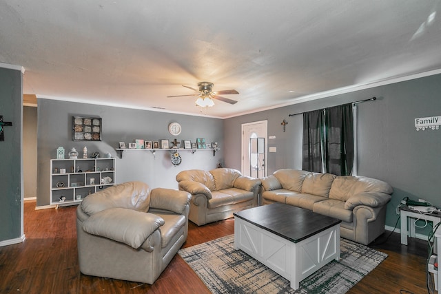 living room featuring crown molding, dark wood-type flooring, and ceiling fan