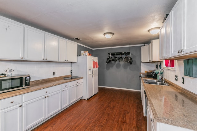 kitchen with white fridge with ice dispenser and white cabinetry