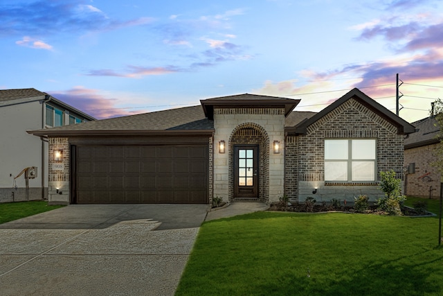 view of front facade with a yard and a garage