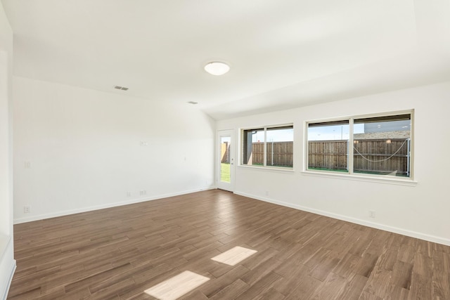 empty room with hardwood / wood-style flooring