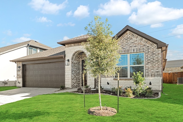 view of front of property with a garage and a front yard