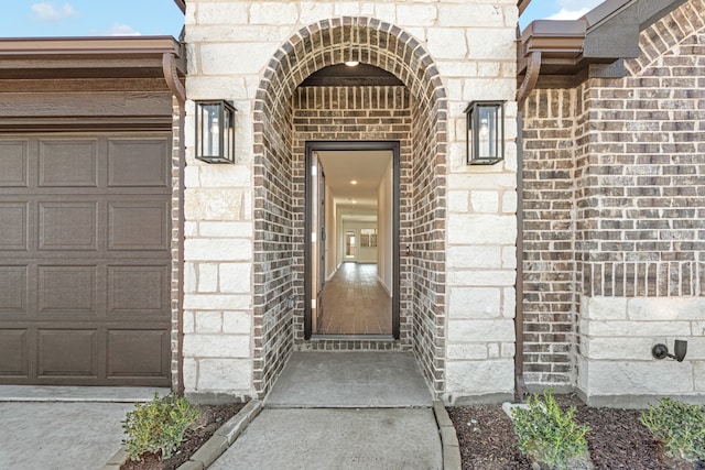 view of exterior entry with a garage