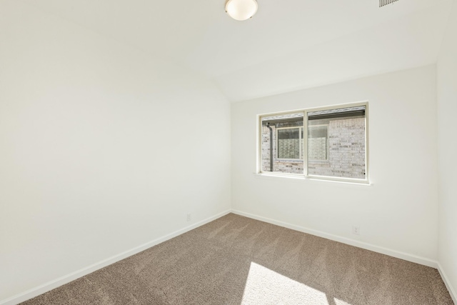 spare room with lofted ceiling and carpet flooring