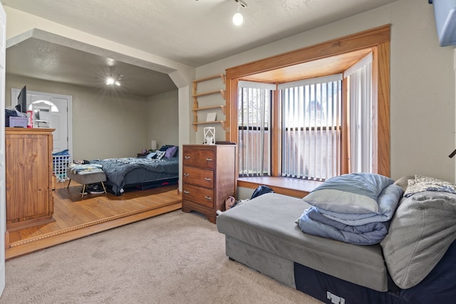 bedroom with hardwood / wood-style flooring and a textured ceiling