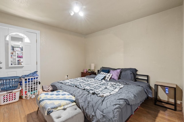 805 S 3rd St, Grandview, TX 76050 - bedroom featuring arched walkways and wood finished floors