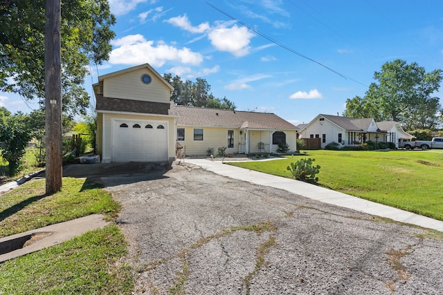 view of front of house with a front yard and a garage