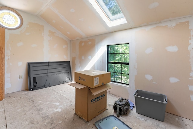 additional living space featuring vaulted ceiling with skylight