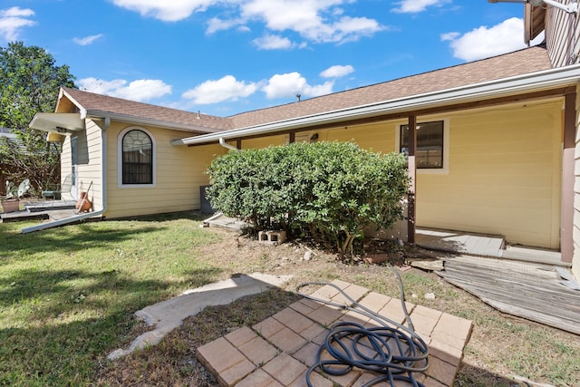 rear view of house featuring a yard and a patio area