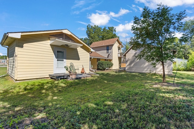 rear view of house featuring a yard