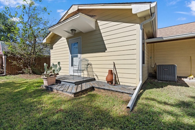 805 S 3rd St, Grandview, TX 76050 - rear view of property with central air condition unit, fence, a wooden deck, and a yard