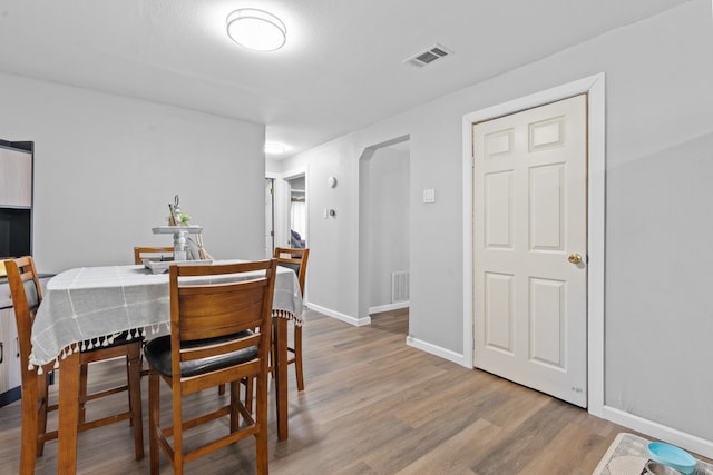 dining space with light hardwood / wood-style flooring