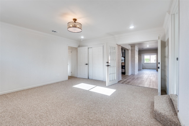 unfurnished bedroom featuring a fireplace, light carpet, and ornamental molding