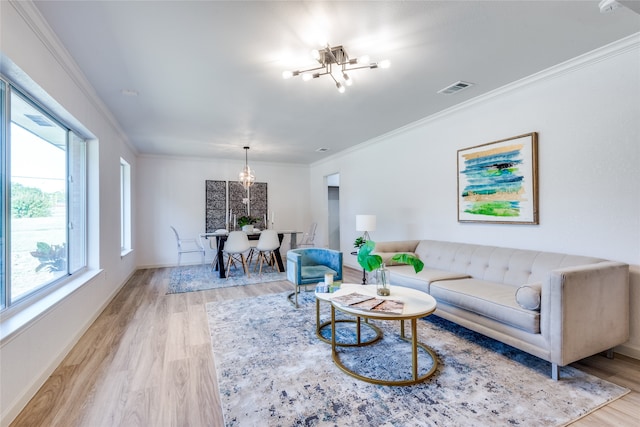 living room featuring light hardwood / wood-style floors and crown molding