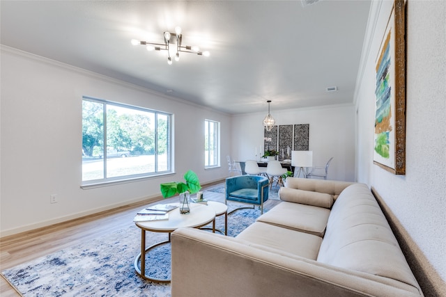 living room featuring hardwood / wood-style flooring, a chandelier, and ornamental molding