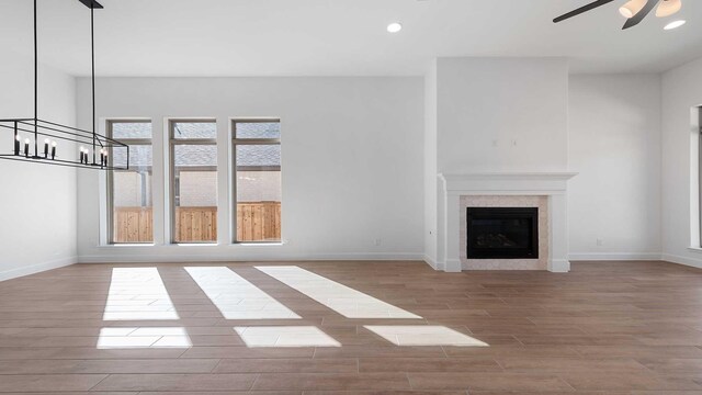 unfurnished living room featuring ceiling fan and light hardwood / wood-style flooring