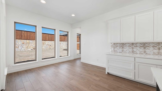 unfurnished dining area featuring hardwood / wood-style floors