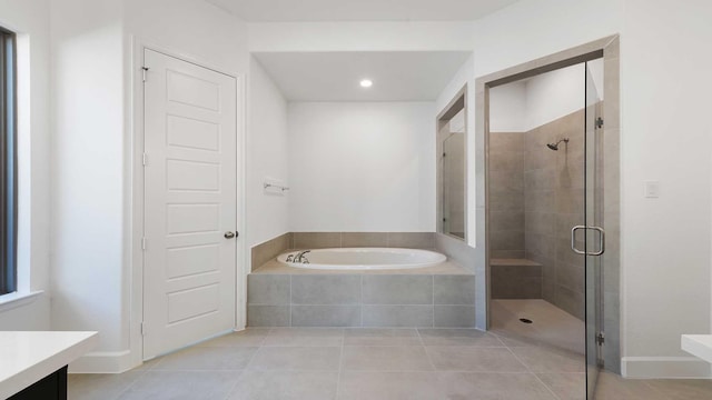 bathroom featuring independent shower and bath, vanity, and tile patterned floors