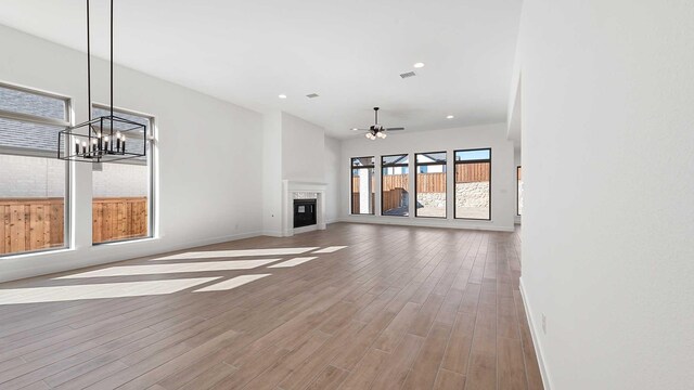 unfurnished living room featuring hardwood / wood-style flooring and ceiling fan