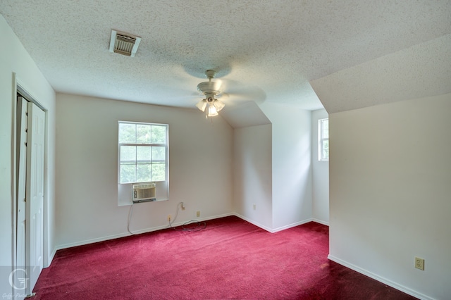 interior space with a textured ceiling, ceiling fan, and carpet flooring