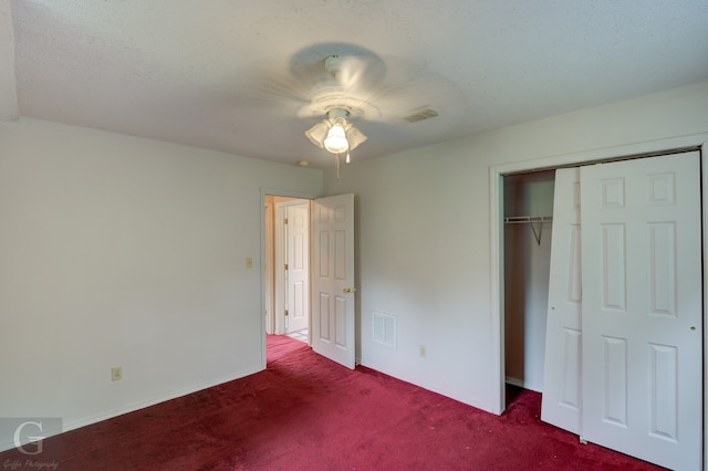 unfurnished bedroom with a closet, a textured ceiling, ceiling fan, and carpet floors