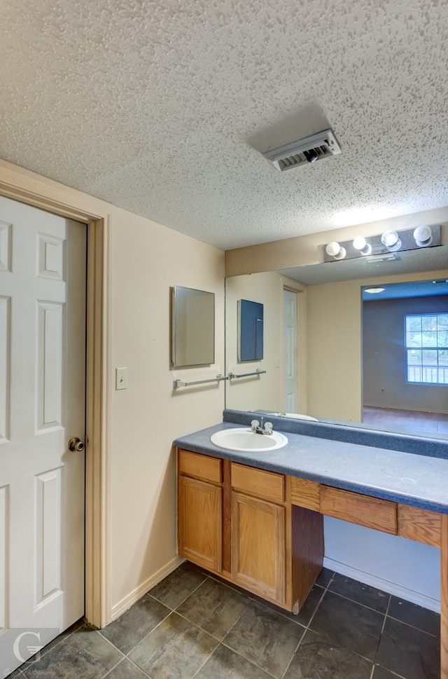 bathroom with vanity and a textured ceiling