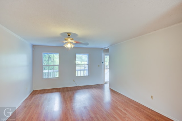 empty room with crown molding, light hardwood / wood-style flooring, and ceiling fan