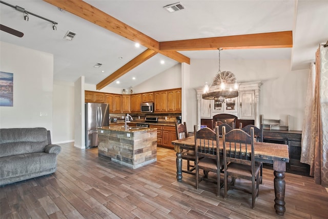 dining room featuring vaulted ceiling with beams, sink, and a chandelier