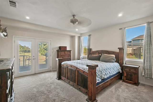 bedroom with ceiling fan, light colored carpet, access to outside, and french doors