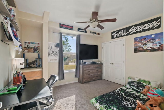 carpeted bedroom with ceiling fan and a closet