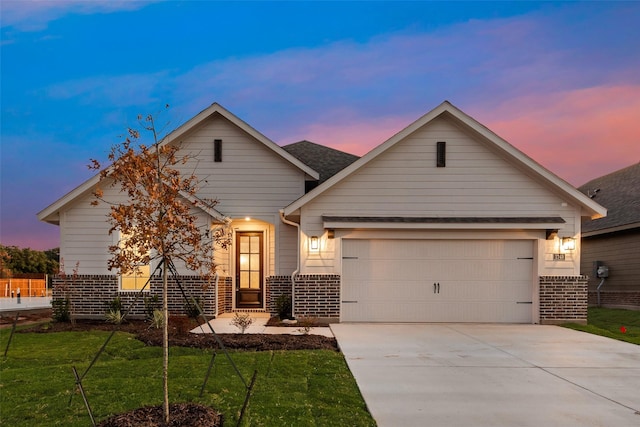 craftsman-style home featuring a yard and a garage