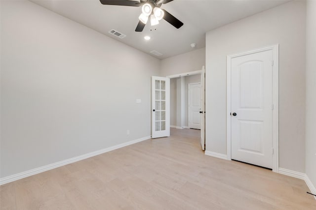 unfurnished bedroom with ceiling fan, french doors, and light wood-type flooring