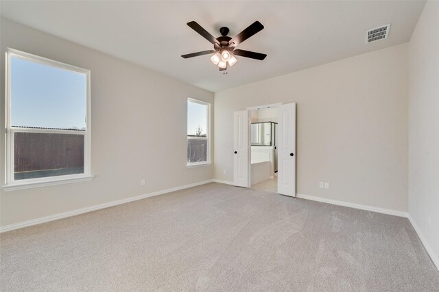 carpeted empty room featuring ceiling fan